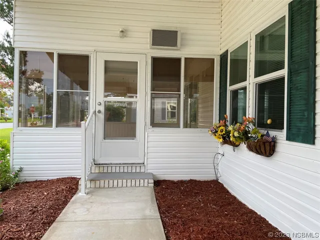 a kitchen with stainless steel appliances a microwave a stove and white cabinets