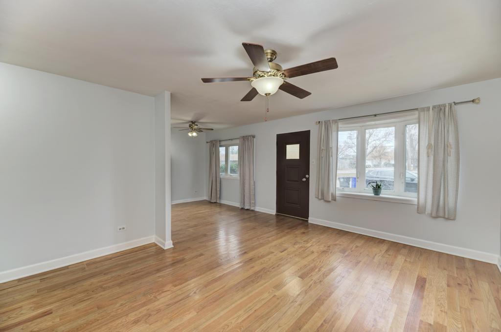 8625 43rd Street Lyons, IL 60534 - Photo 3 of 22 a view of an empty room with a window and wooden floor