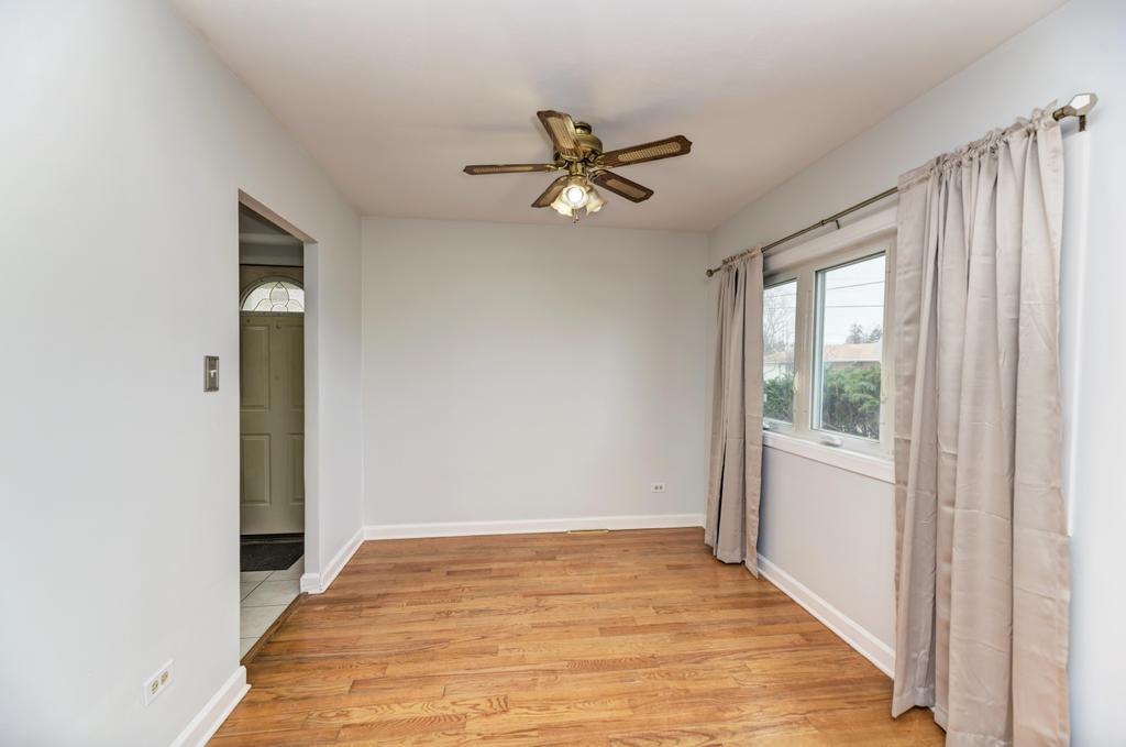 8625 43rd Street Lyons, IL 60534 - Photo 8 of 22 a view of empty room with wooden floor and fan