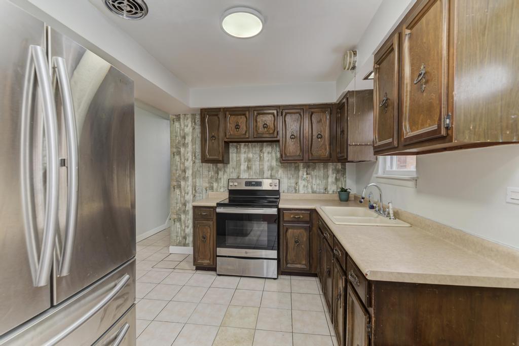 8625 43rd Street Lyons, IL 60534 - Photo 9 of 22 a kitchen with stainless steel appliances granite countertop a refrigerator sink and stove
