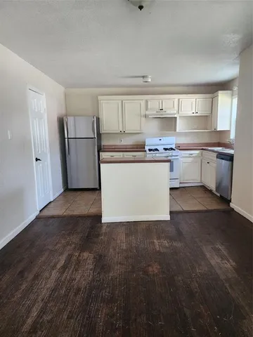 a kitchen with a refrigerator and a sink