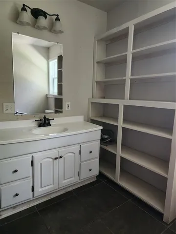 a bathroom with a double vanity sink and a mirror
