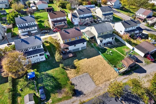 an aerial view of a houses with yard