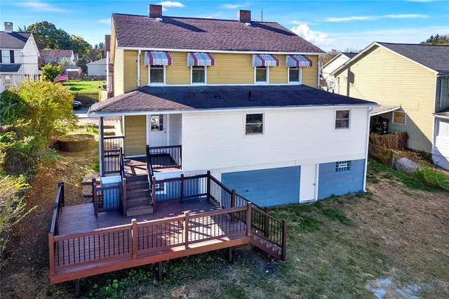 a view of a house with a yard and sitting area
