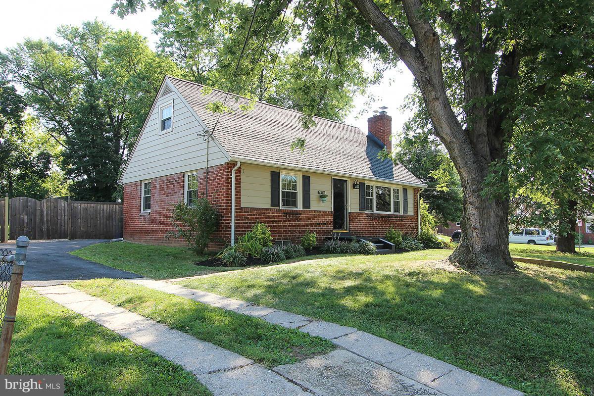 12701 Holdridge Road Silver Spring, MD 20906 - Photo 3 of 30 a view of a yard in front of a house with a large tree
