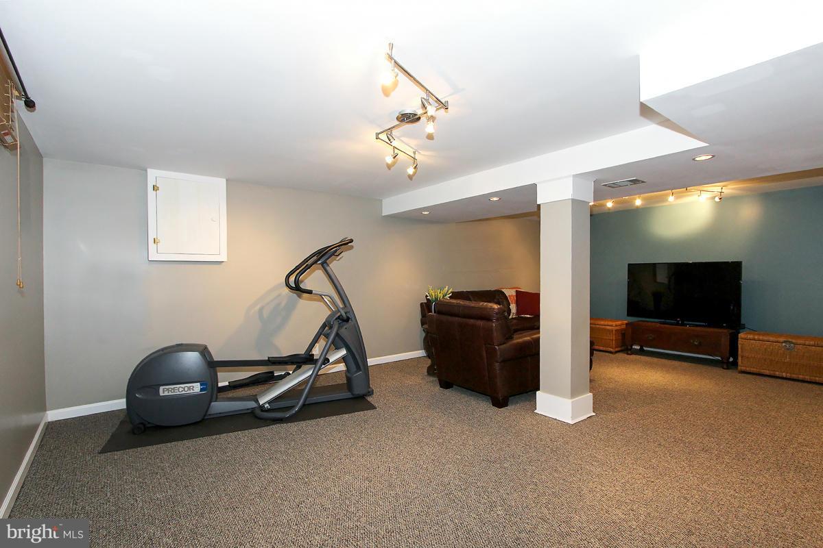 12701 Holdridge Road Silver Spring, MD 20906 - Photo 23 of 30 a room with gym equipment and a flat screen tv
