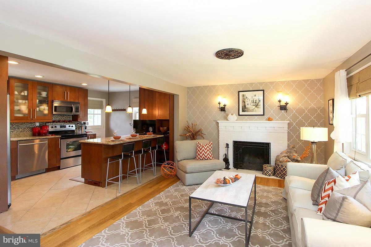 12701 Holdridge Road Silver Spring, MD 20906 - Photo 5 of 30 a living room with furniture and a fireplace