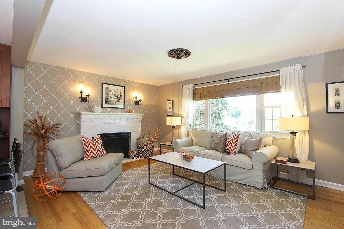 12701 Holdridge Road Silver Spring, MD 20906 - Photo 6 of 30 a living room with furniture and a fireplace
