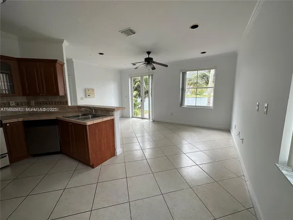 a kitchen with granite countertop a stove a sink a window and a counter top space