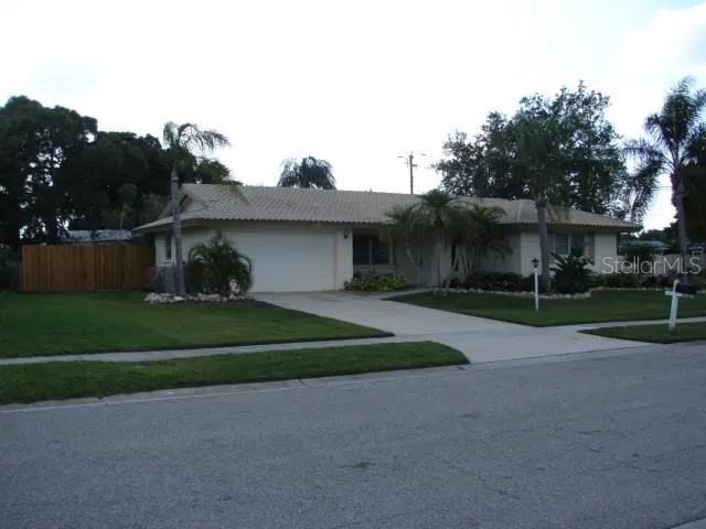 a view of a house with a yard and a fountain