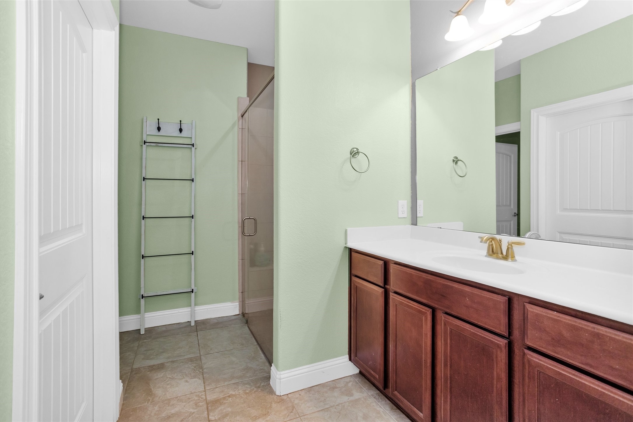 30806 Mellman Road Hempstead, TX 77445 - Photo 13 of 35 A primary bath with beautiful tile floors and handicap accessible shower.