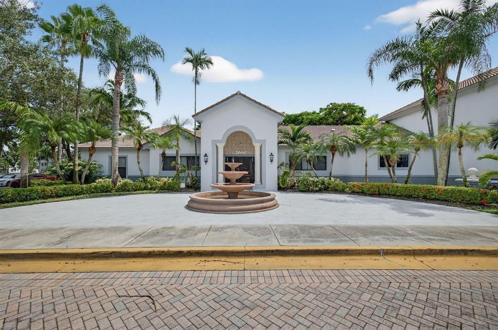 2640 South University Drive, Unit 129 Davie, FL 33328 - Photo 1 of 15 a house with palm tree in front of it