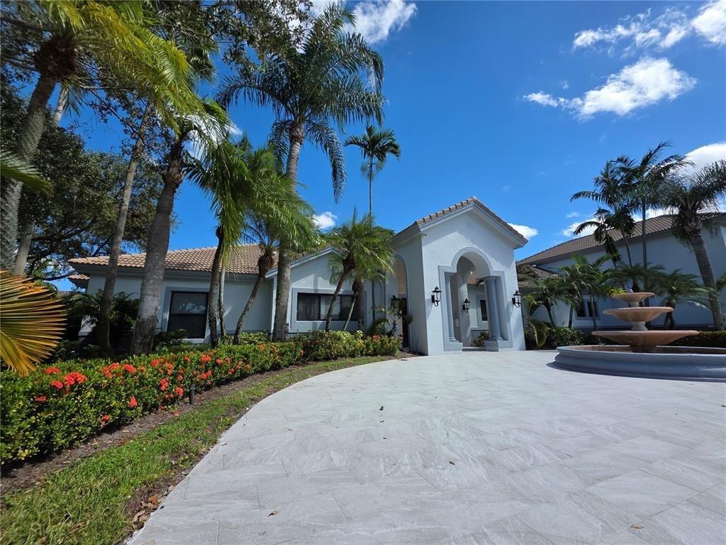2640 South University Drive, Unit 129 Davie, FL 33328 - Photo 3 of 15 a view of a house with a yard and potted plants