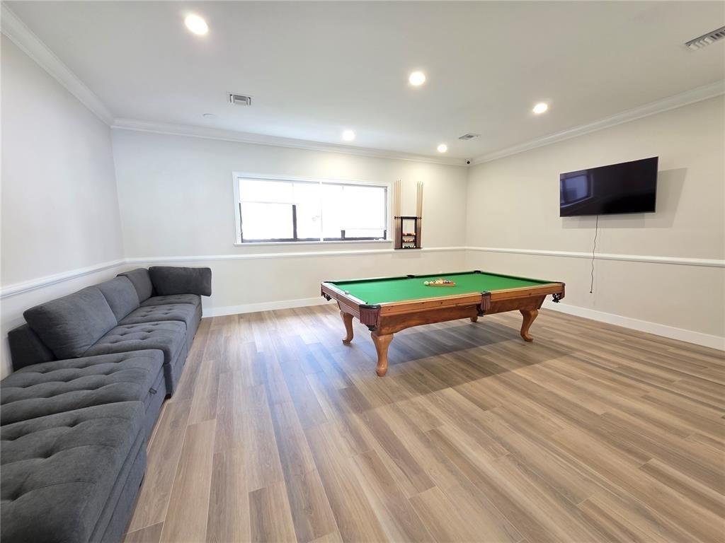 2640 South University Drive, Unit 129 Davie, FL 33328 - Photo 6 of 15 a living room with furniture and a flat screen tv