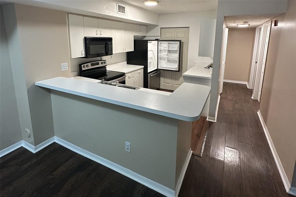 2640 South University Drive, Unit 129 Davie, FL 33328 - Photo 9 of 15 a room with furniture and a flat screen tv