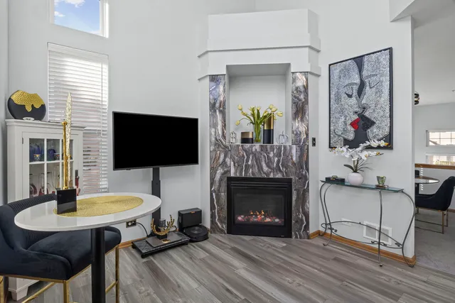 a living room with furniture a flat screen tv and a fireplace