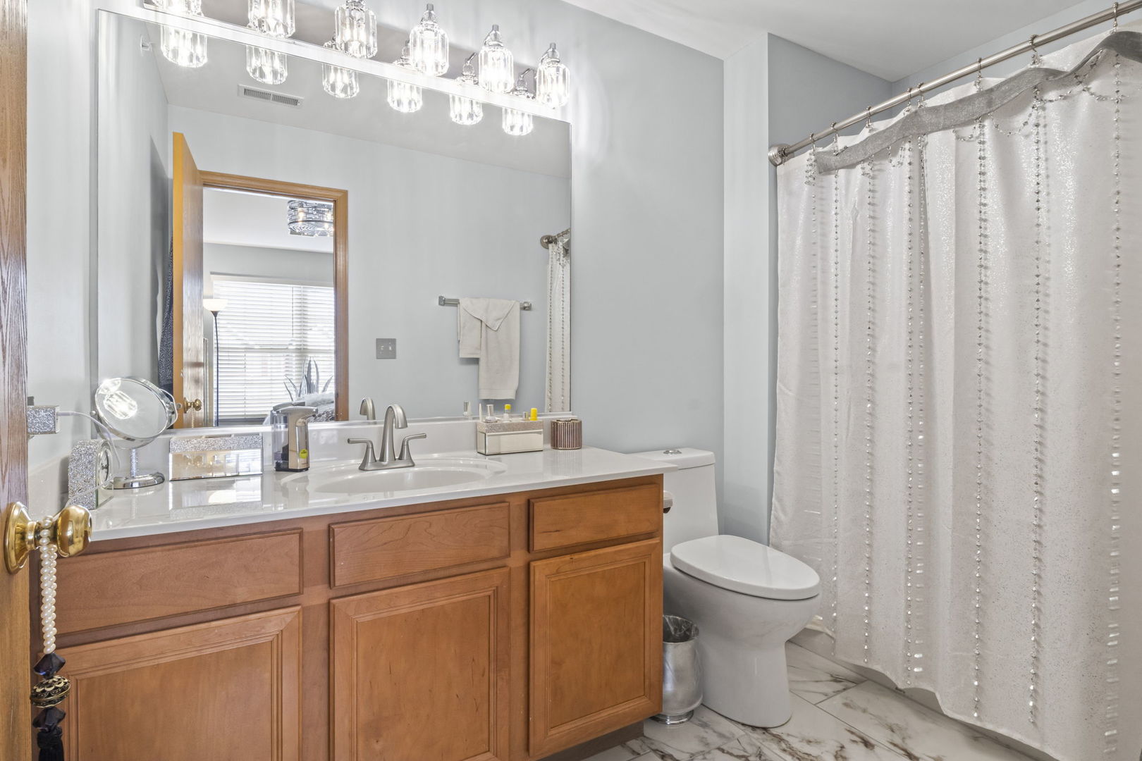 21617 Dogwood Road, Unit 1125 Matteson, IL 60443 - Photo 21 of 33 a bathroom with a toilet a sink and a large mirror
