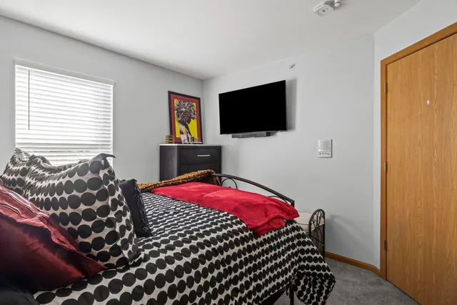 a bedroom with a bed and a flat screen tv