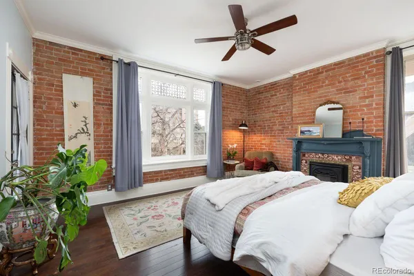 a bedroom with a bed and a potted plant