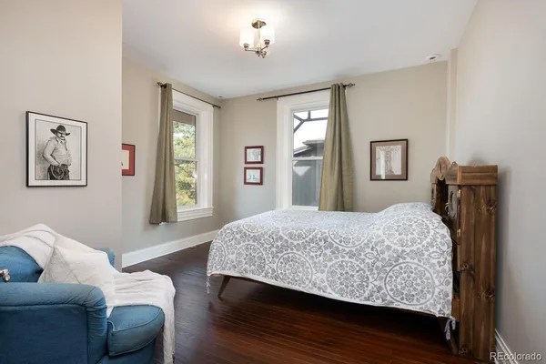 a bedroom with a bed couch and a window