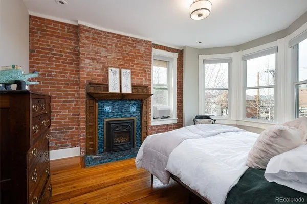 a spacious bedroom with a bed and a fireplace