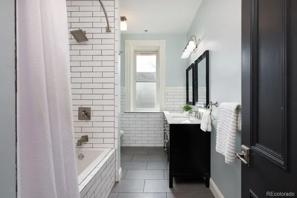 a bathroom with a bathtub and a sink