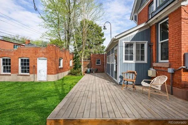 a view of a house with backyard and sitting area