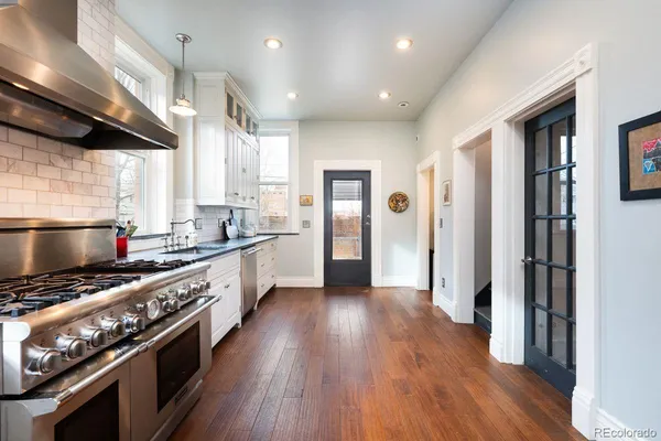 a kitchen with stainless steel appliances granite countertop a stove and a refrigerator