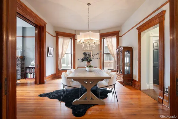 a dining room with furniture wooden floor a chandelier
