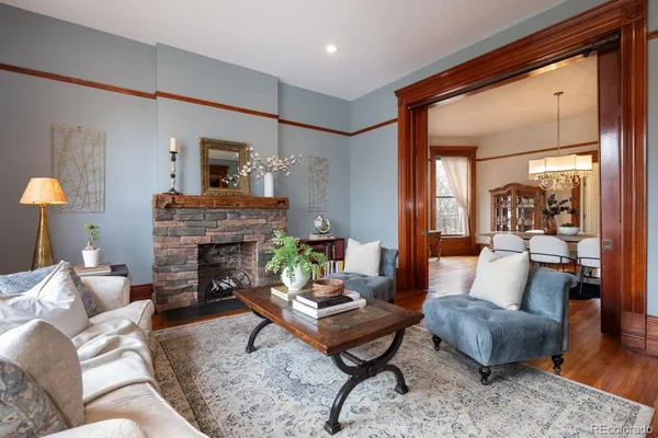 a living room with furniture and a fireplace