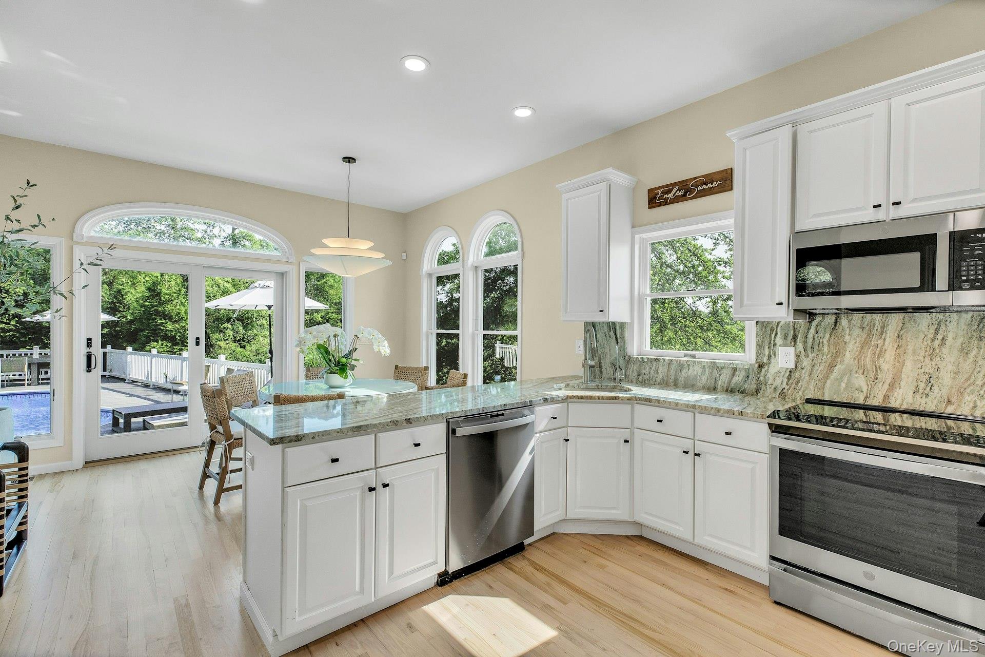 56 South Country Road Westhampton, NY 11977 - Photo 11 of 43 a kitchen with a sink stove and cabinets