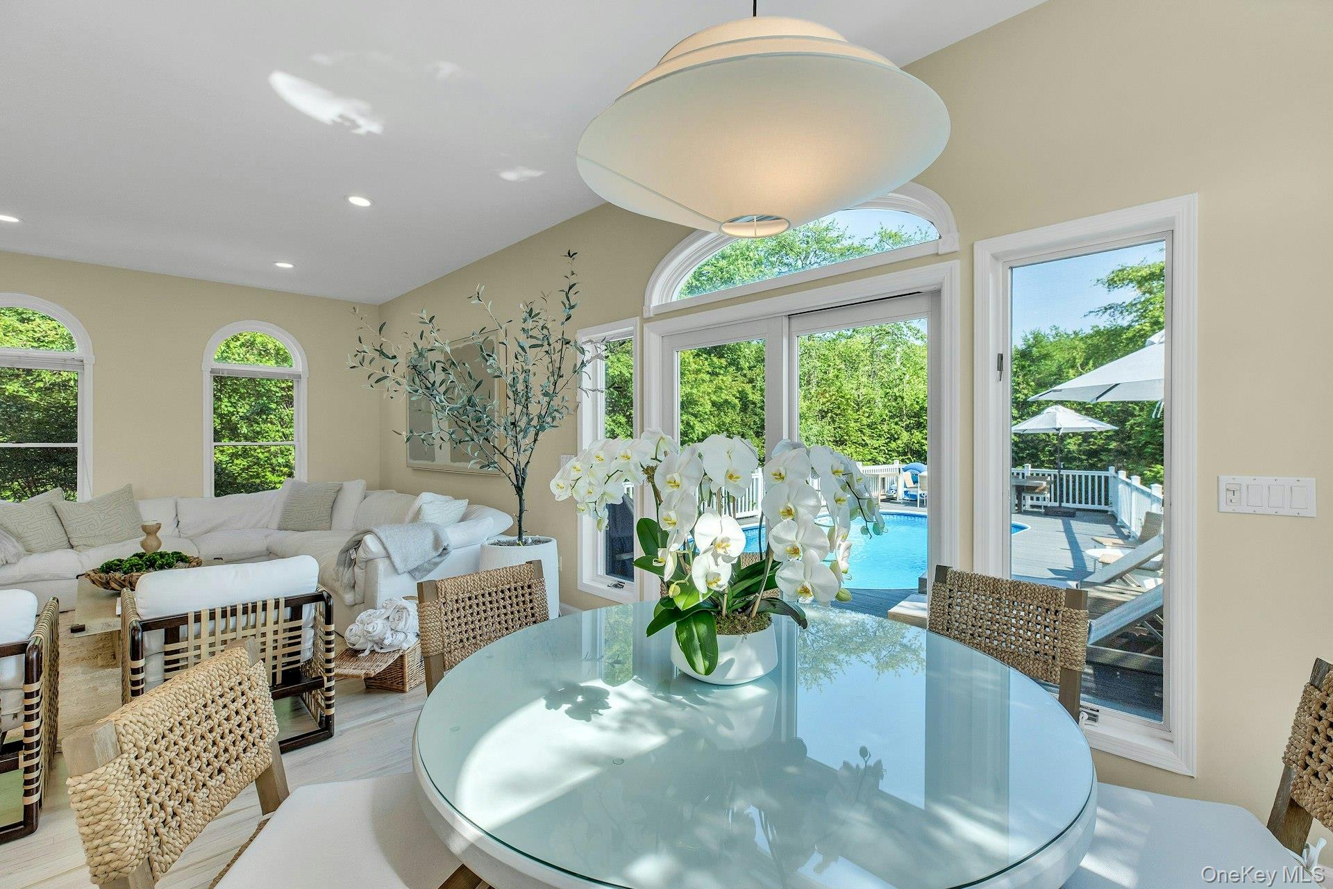 56 South Country Road Westhampton, NY 11977 - Photo 14 of 43 a dining room with furniture a chandelier and wooden floor