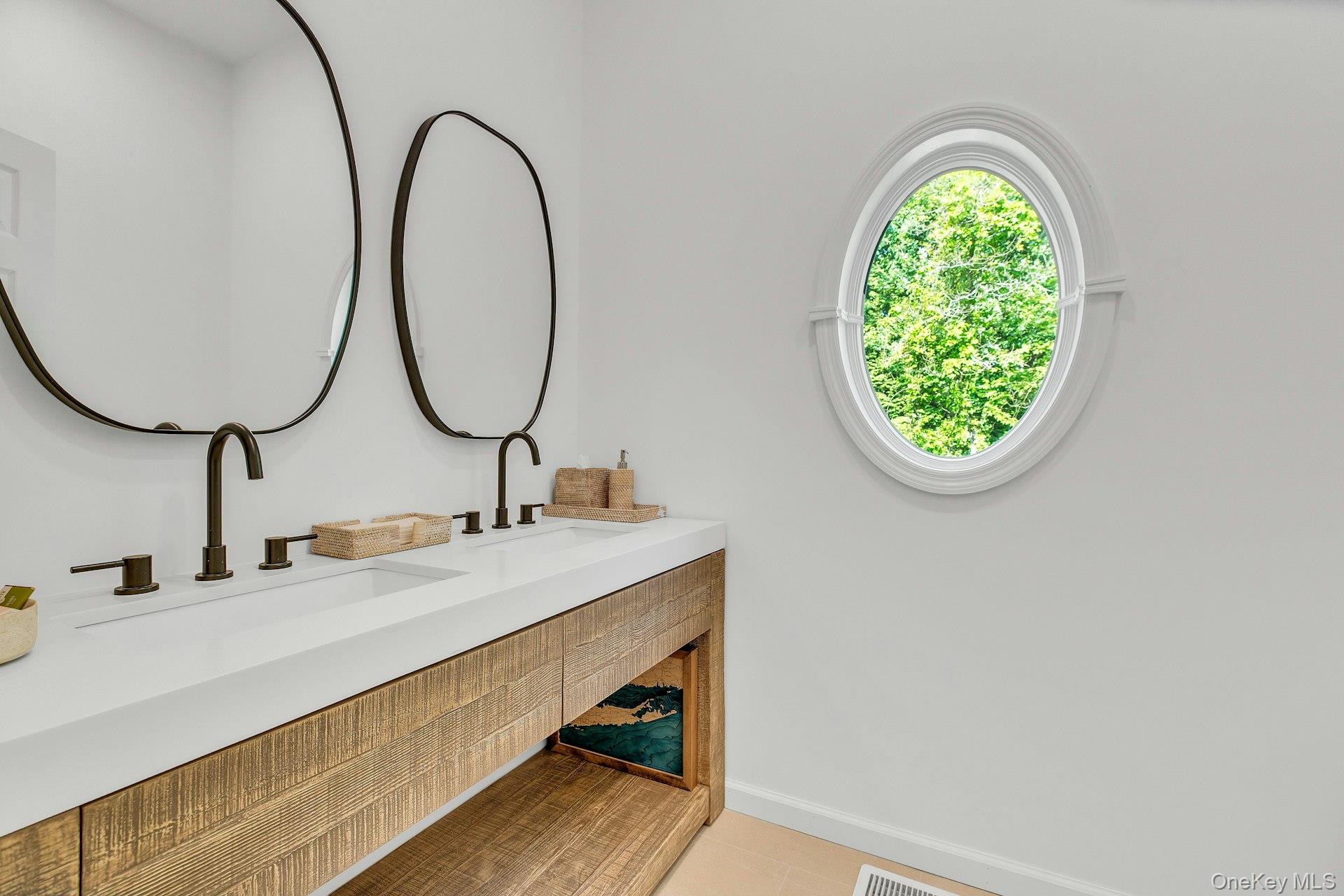 56 South Country Road Westhampton, NY 11977 - Photo 15 of 43 a bathroom with a sink and a mirror