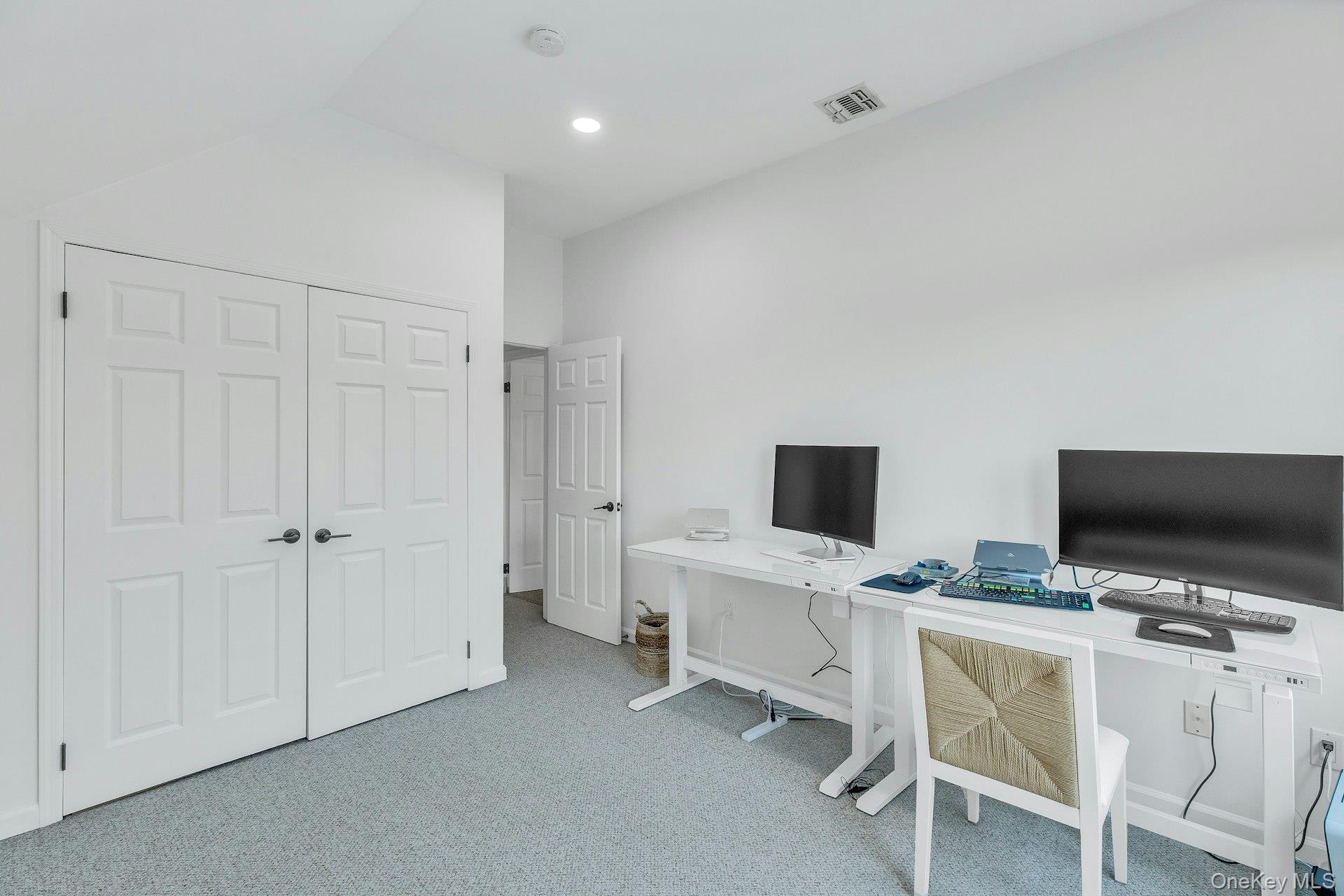 56 South Country Road Westhampton, NY 11977 - Photo 28 of 43 a view of a workspace with a flat screen tv and a window