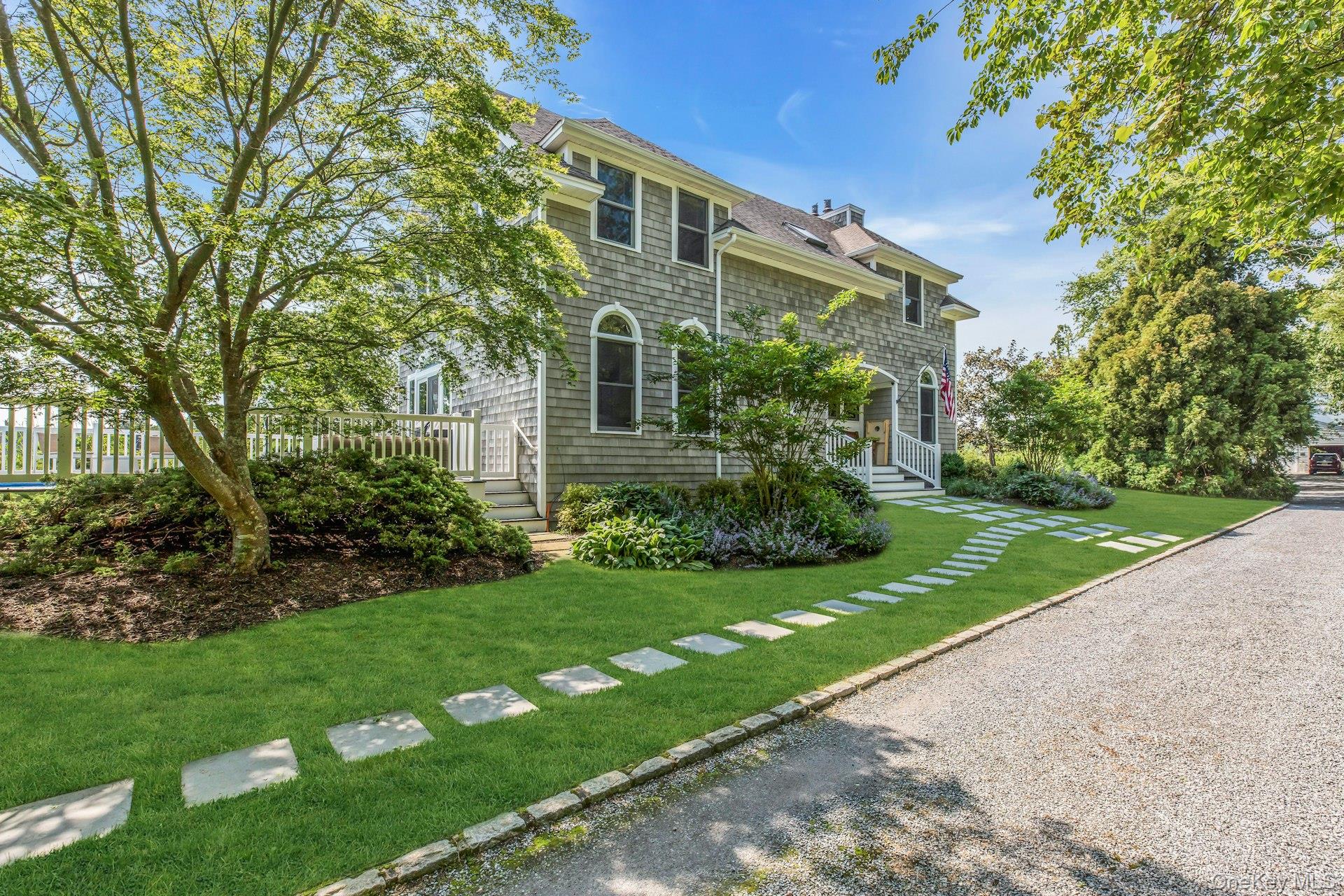 56 South Country Road Westhampton, NY 11977 - Photo 3 of 43 a front view of a house with a yard