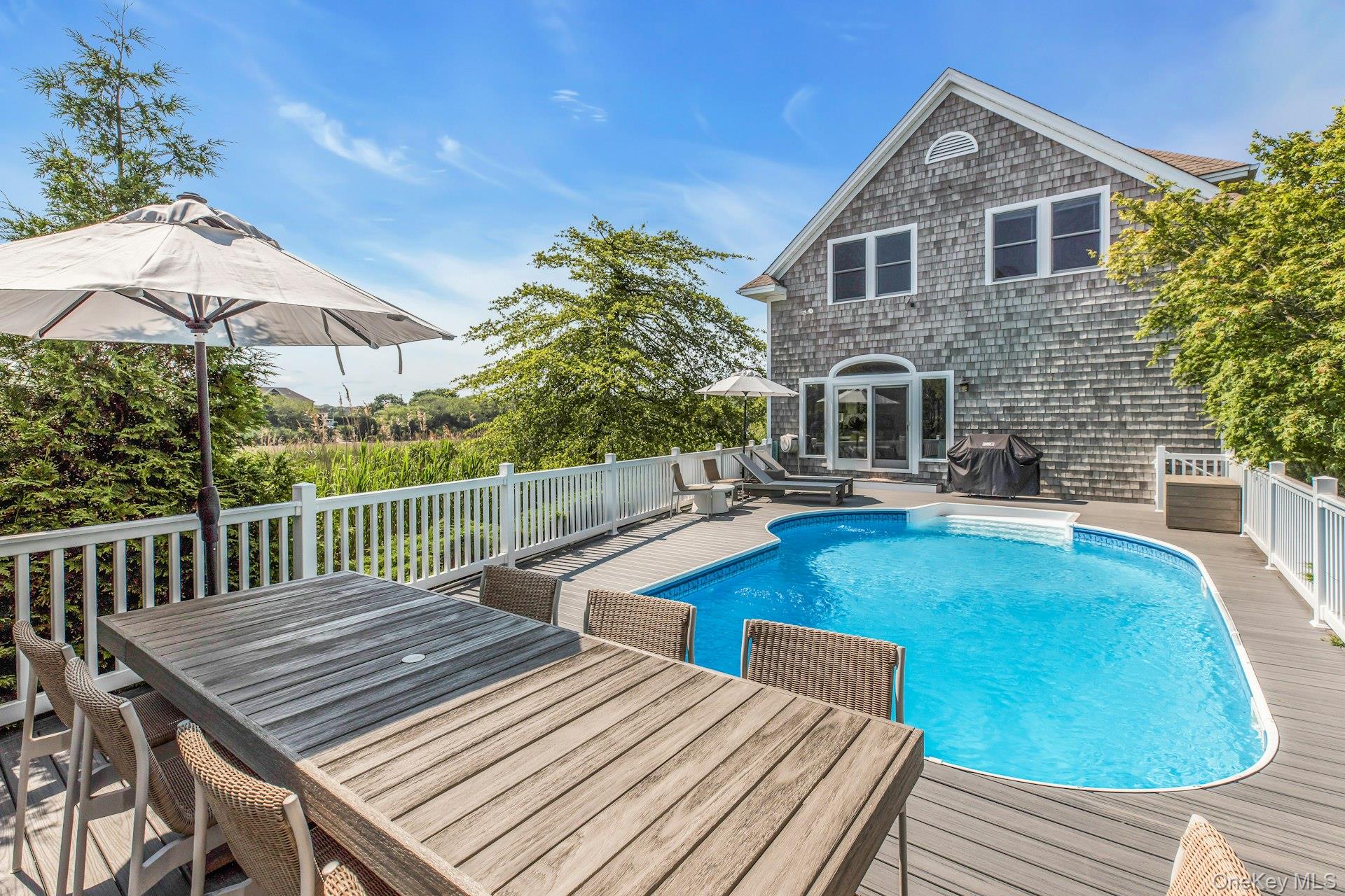 56 South Country Road Westhampton, NY 11977 - Photo 35 of 43 a view of a house with pool and chairs