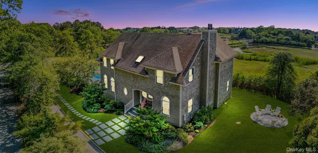 a aerial view of a house with pool garden and lake view