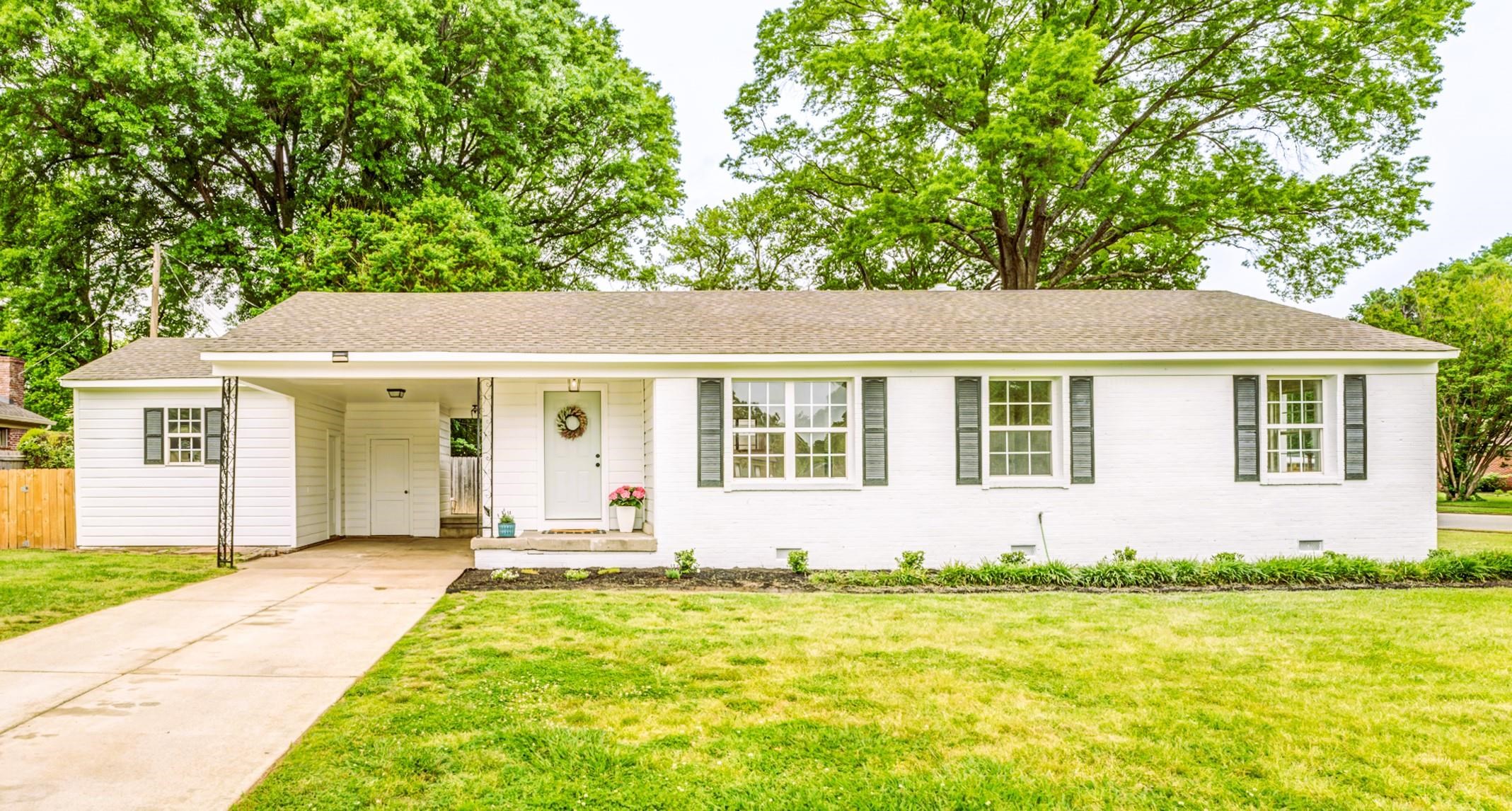 5600 Manley Road Memphis, TN 38120 - Photo 1 of 31 a front view of a house with a garden and ceiling tree