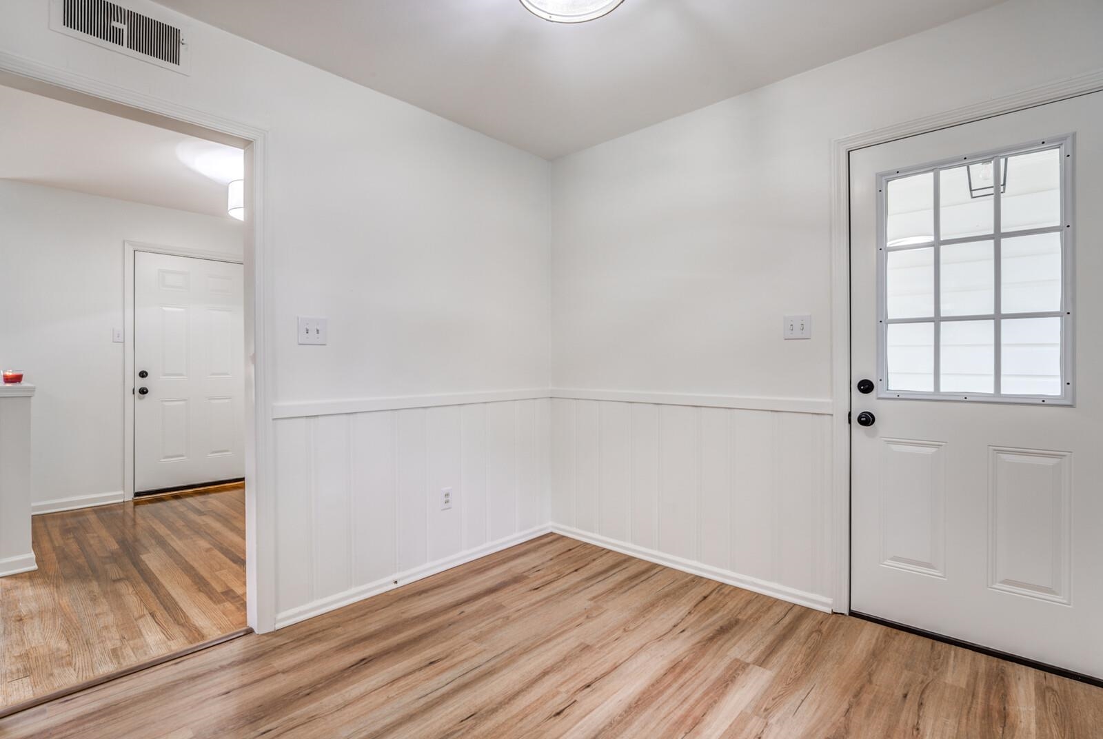 5600 Manley Road Memphis, TN 38120 - Photo 11 of 31 an empty room with wooden floor and cabinet