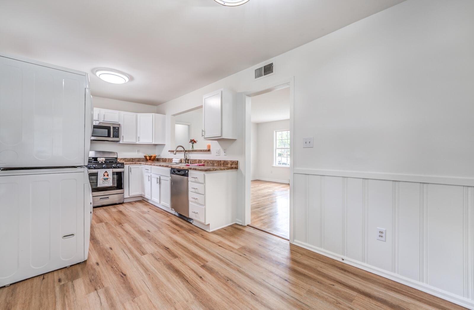 5600 Manley Road Memphis, TN 38120 - Photo 12 of 31 a kitchen with white cabinets and stainless steel appliances