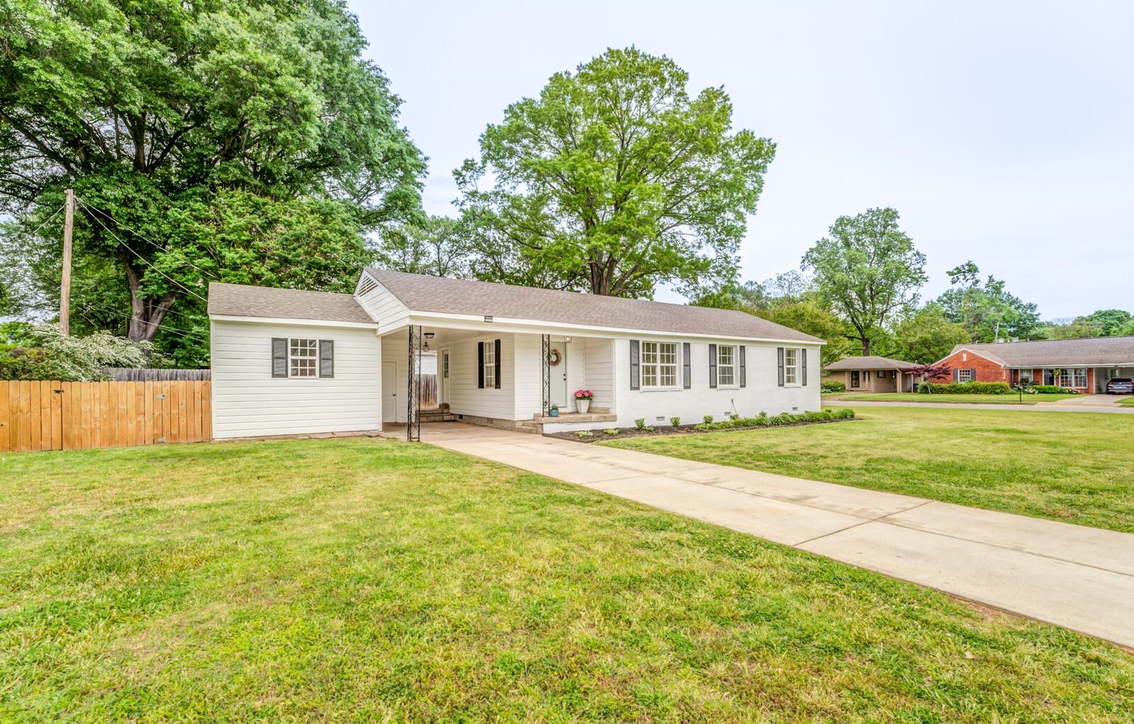 5600 Manley Road Memphis, TN 38120 - Photo 2 of 31 a view of a house and a yard with plants and trees