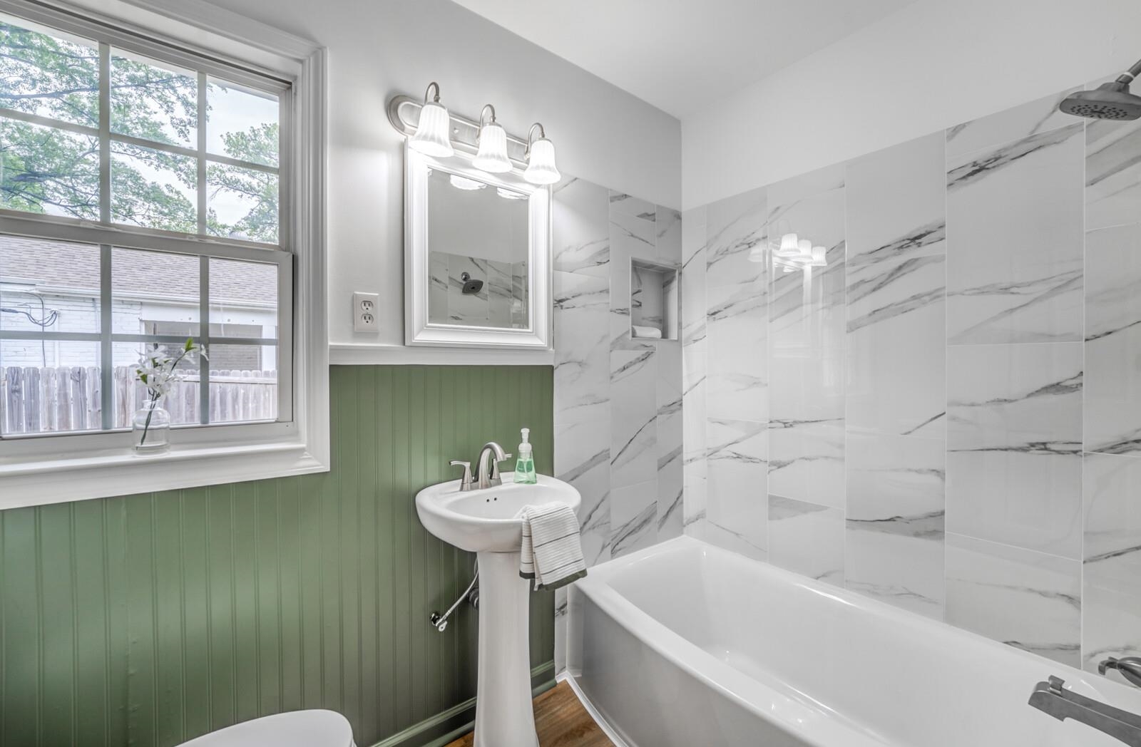 5600 Manley Road Memphis, TN 38120 - Photo 25 of 31 a bathroom with a sink a toilet and bathtub