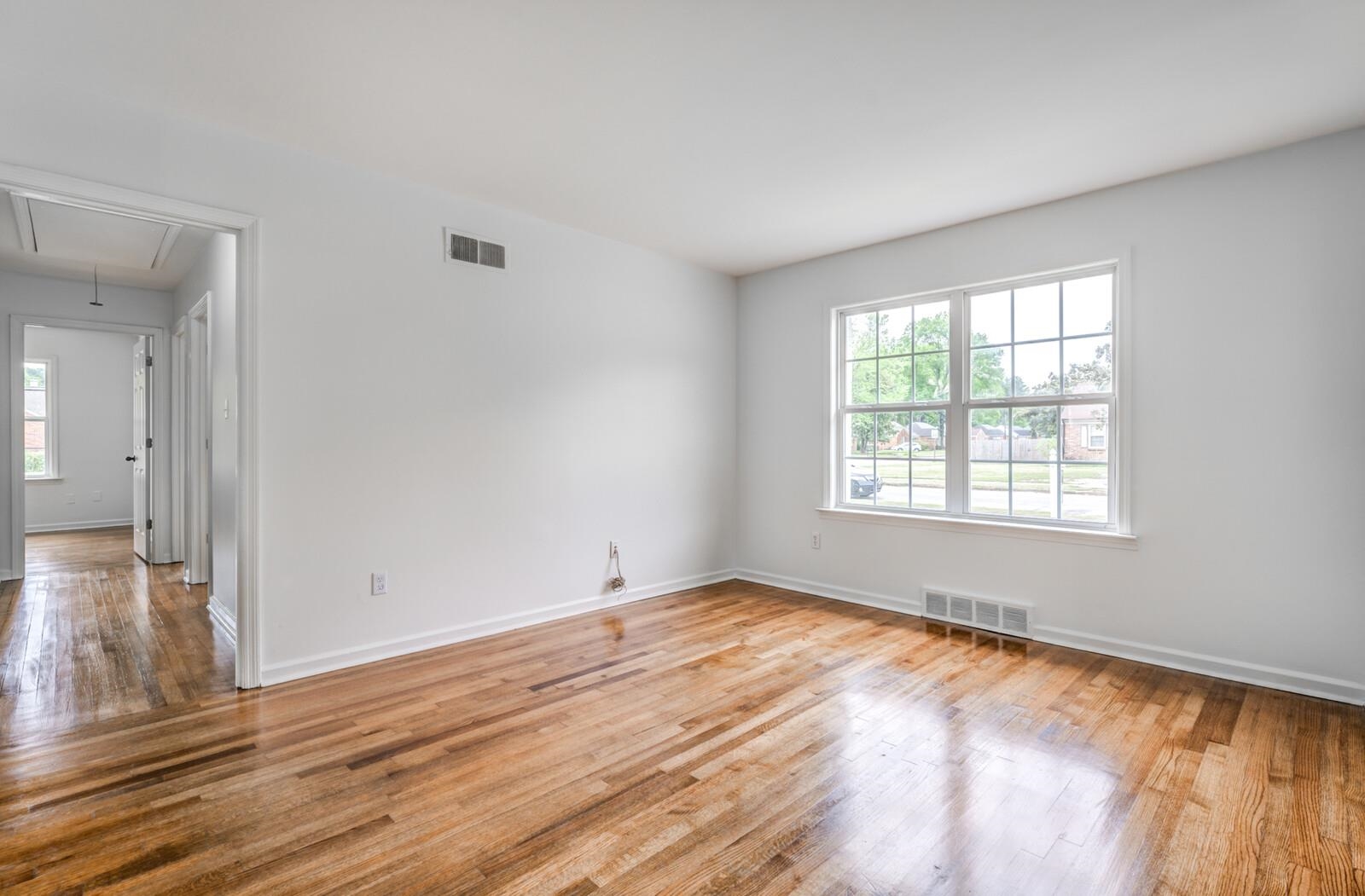 5600 Manley Road Memphis, TN 38120 - Photo 6 of 31 a view of an empty room with wooden floor and a window