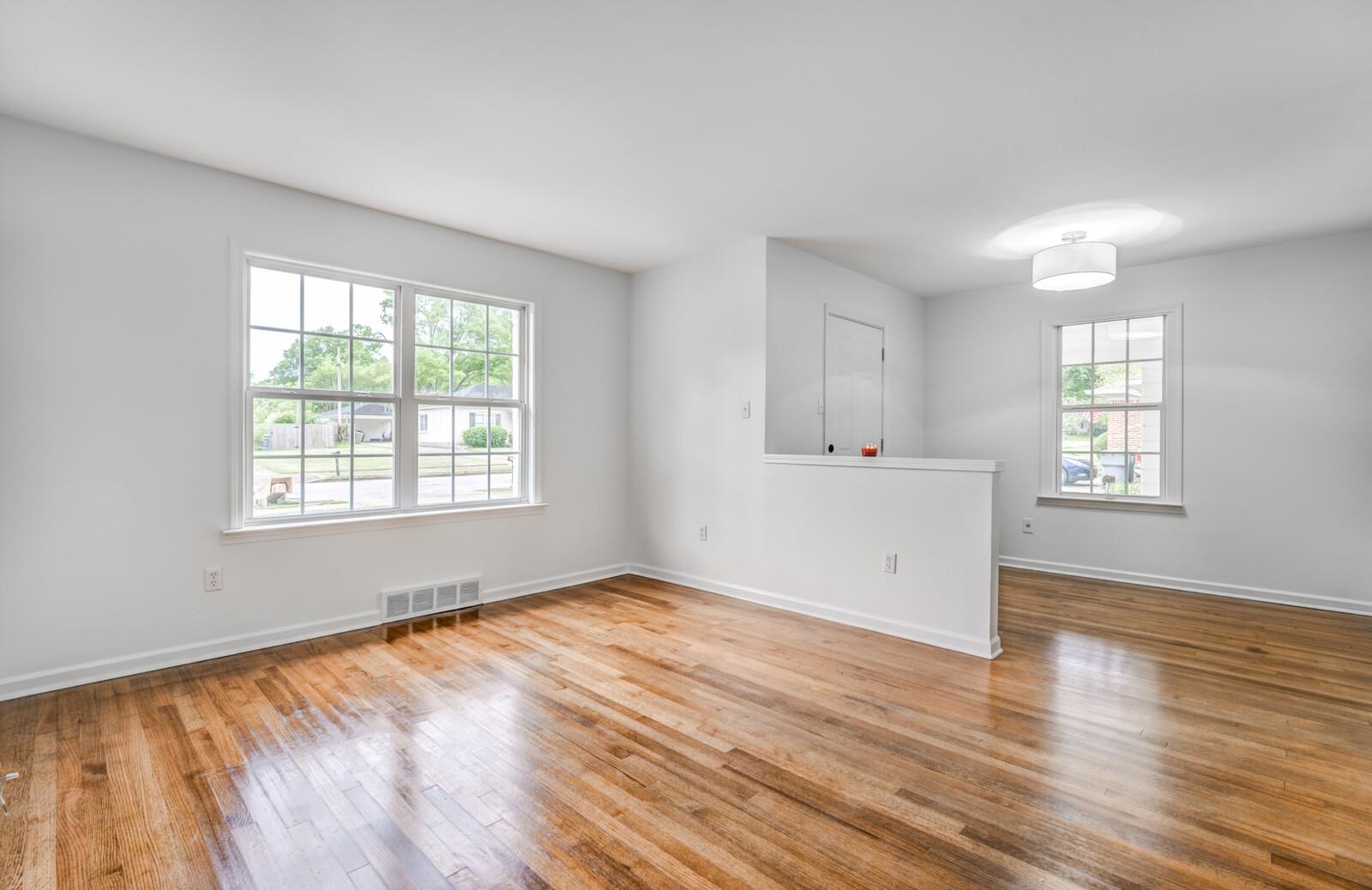 5600 Manley Road Memphis, TN 38120 - Photo 7 of 31 an empty room with wooden floor and windows