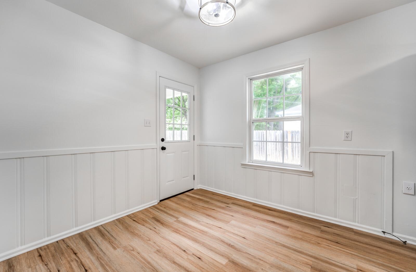 5600 Manley Road Memphis, TN 38120 - Photo 10 of 31 an empty room with wooden floor and windows