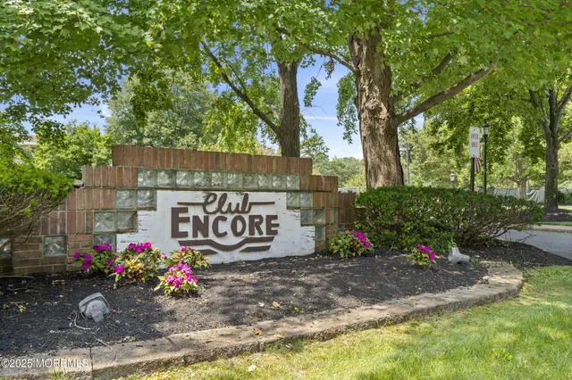 a living room with furniture kitchen view and a large window