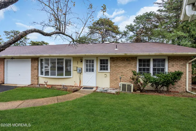 a view of a house with a yard and plants