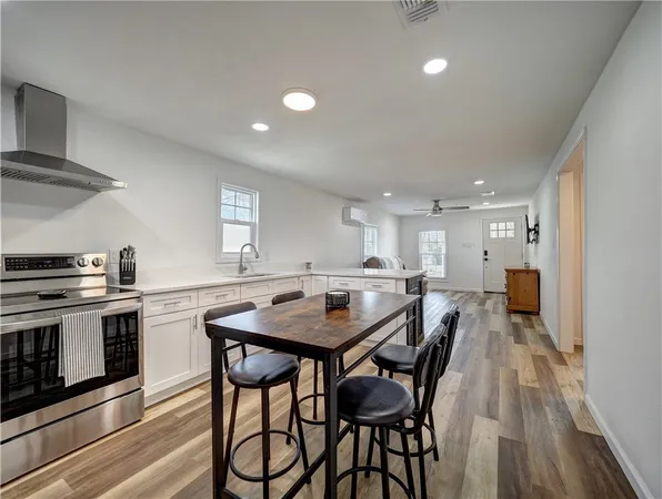 a kitchen that has a table and chairs in it
