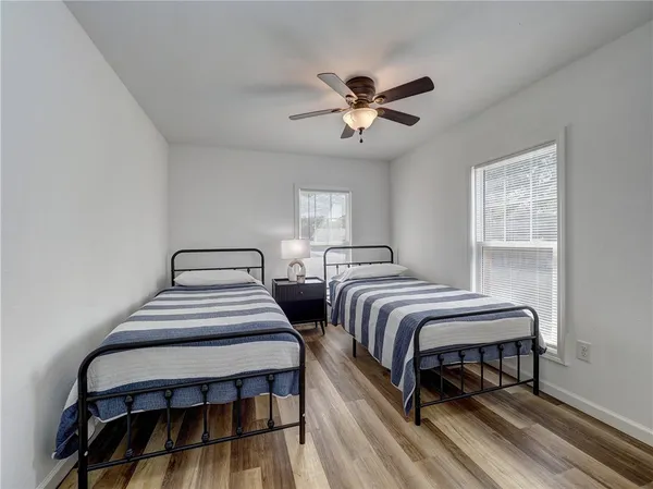 a bedroom with two beds and a chandelier