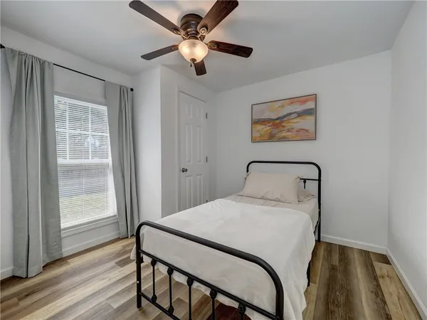 a bedroom with a bed and a window